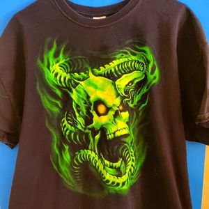 Rock on in our bold black 2XL tee with green skull and snake design. Comfortable